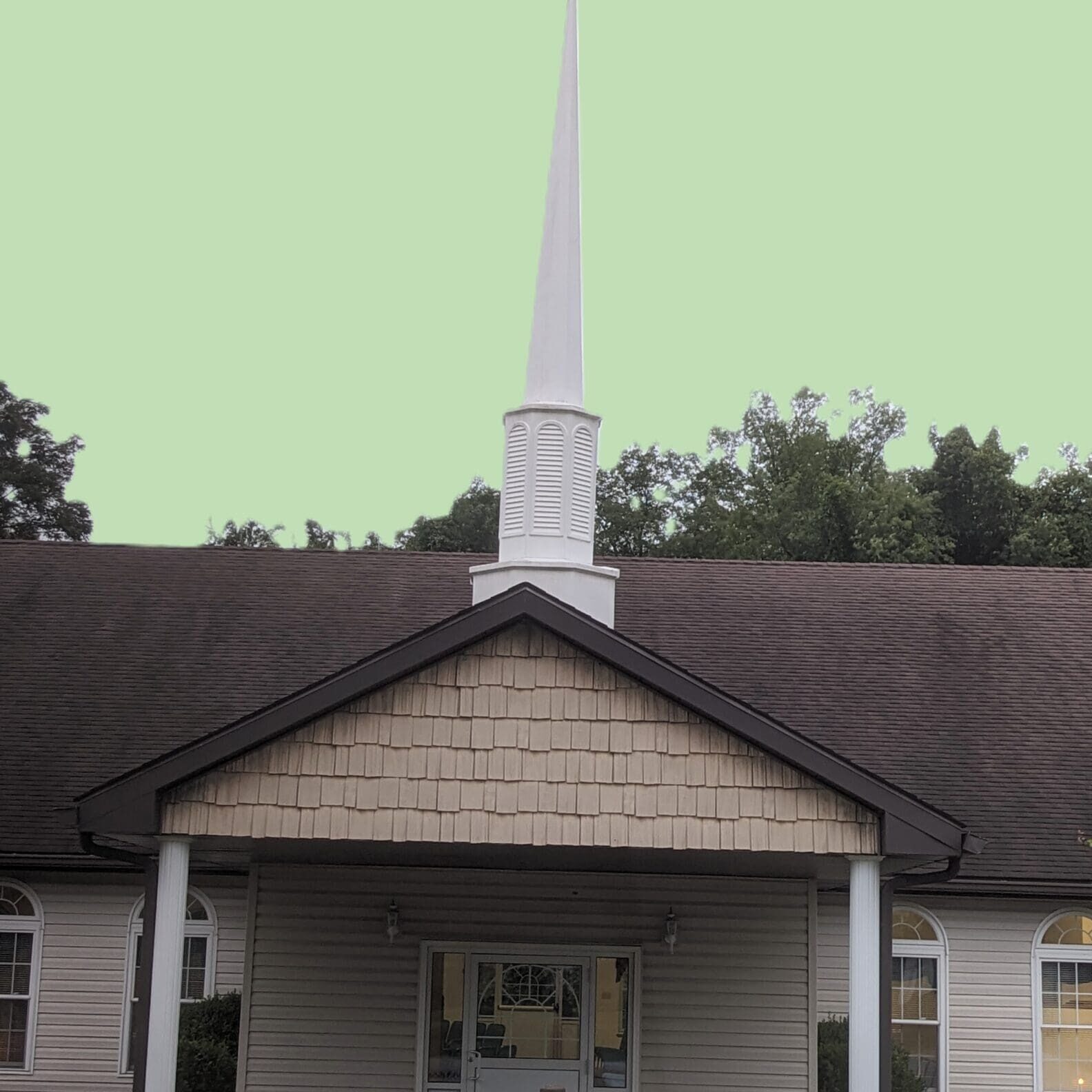 A church with a steeple and a large building